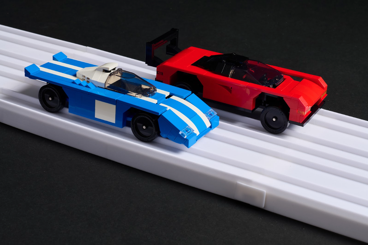 Two Brick Derby cars racing side by side on the Fast Track